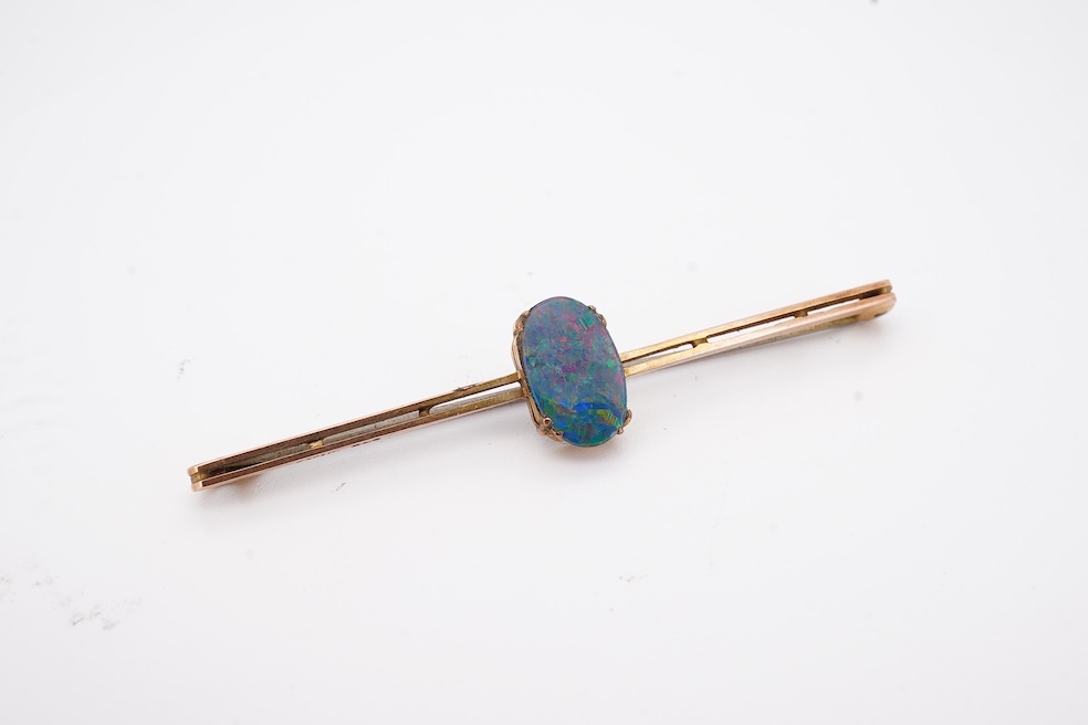 An early 20th century 9ct and single stone oval black opal doublet set bar brooch, 57mm, gross weight 2.3 grams, in an Asprey box. Condition - fair